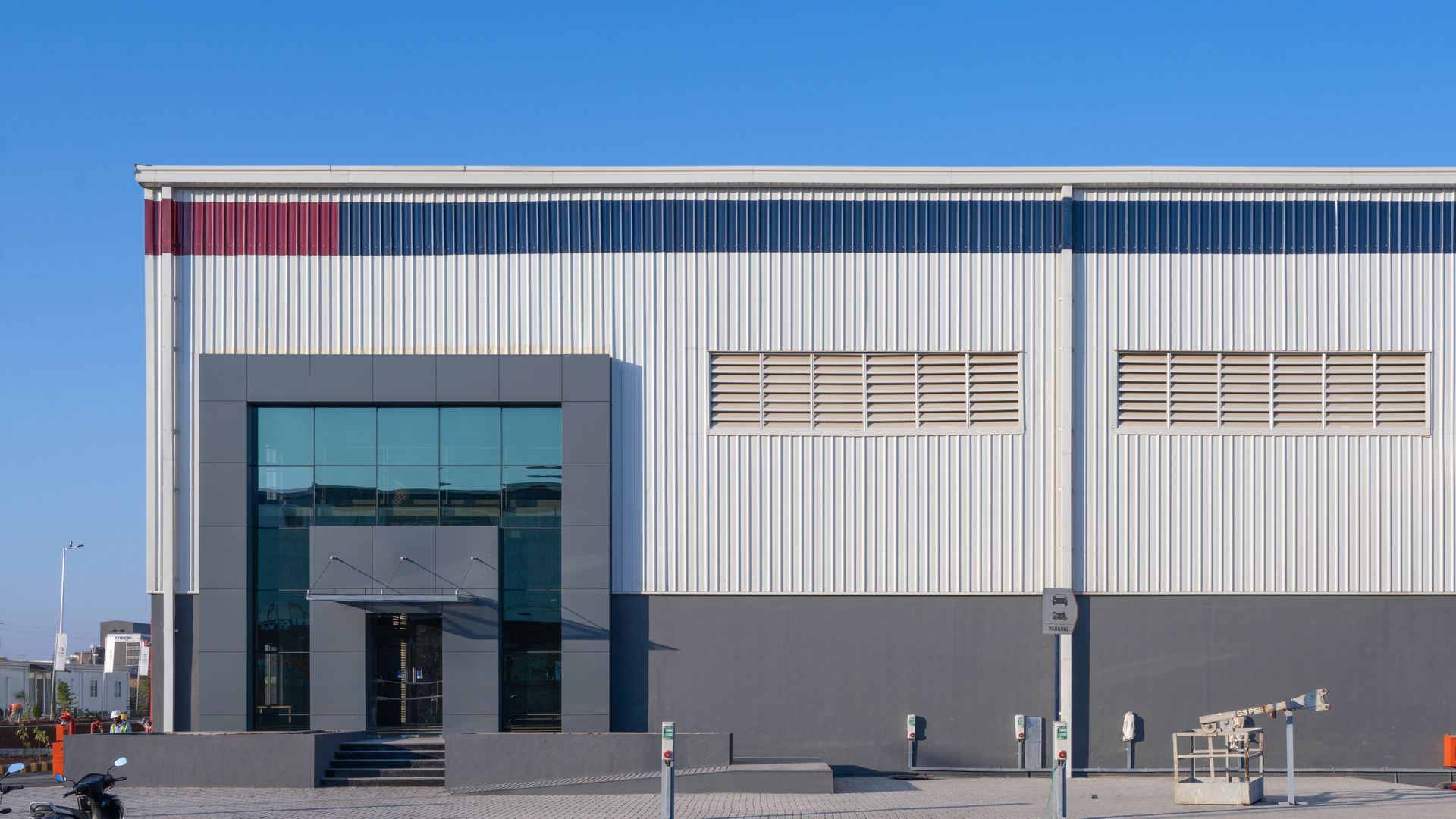 Architectural rendering of ESR Delhi Urban Distribution Centre with trucks at loading bays.
